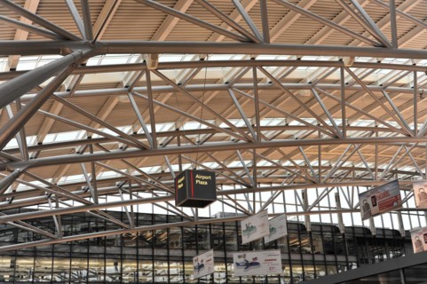 Modern architecture in the interior of an airport with a wayfinding system on the ceiling, Hamburg,