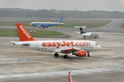 EasyJet aircraft on the tarmac next to airport vehicles, Hamburg, Hanseatic City of Hamburg,