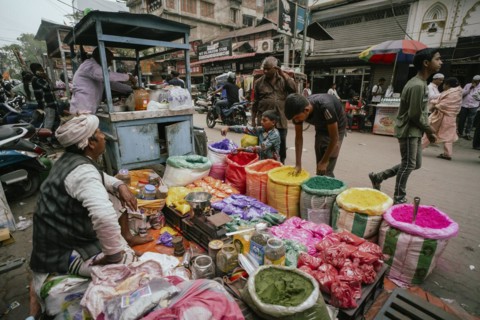 Vendor sells Holi celebration items in a street market, ahead of Holi festival on March 23, 2024 in