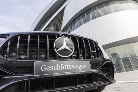 Mercedes company car, radiator grille and Mercedes star on a modern vehicle, in the background the