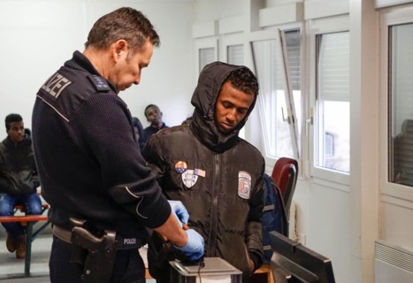 Refugees are registered and recorded by the Federal Police in Rosenheim. A Federal Police officer