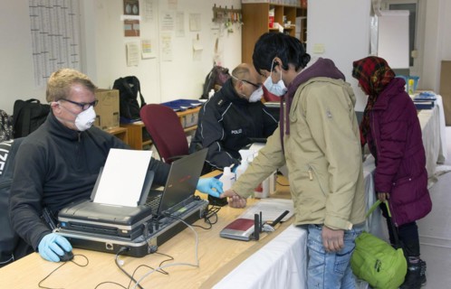 Refugees are registered and recorded by the Federal Police in Rosenheim. A Federal Police officer