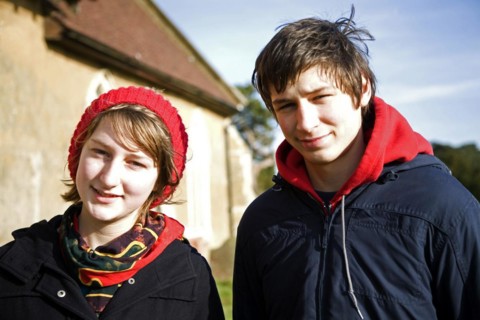 Model released head and shoulders portrait of boy and girl twins standing together in winter,