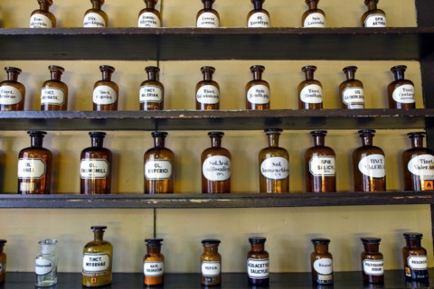Containers with ingredients for medicines stand on a shelf in the historic Berg-Apotheke pharmacy