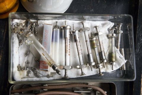 Old syringes in a bowl stand in the former laboratory of the historic Berg-Apotheke pharmacy in