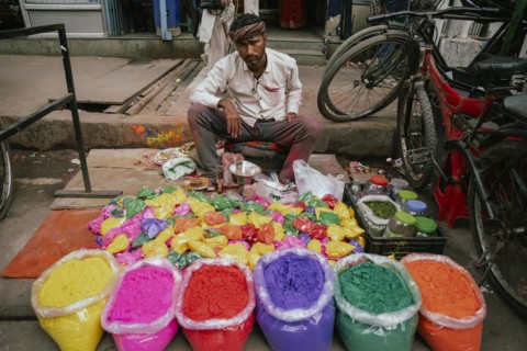 Vendor sells Holi celebration items in a street market, ahead of Holi festival on March 23, 2024 in