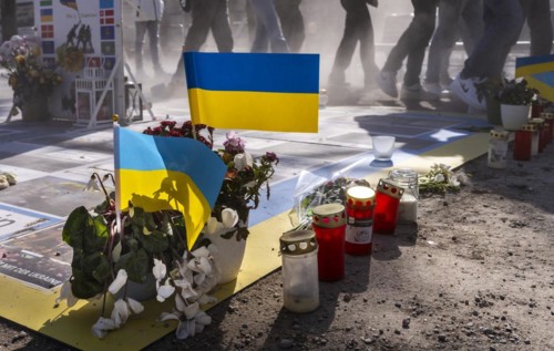 Mourners with flags and flowers in front of the Russian Embassy Unter den Linden, Berlin, Germany,