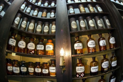 Glass jars with ingredients for medicines stand on a shelf in the historic Berg-Apotheke pharmacy