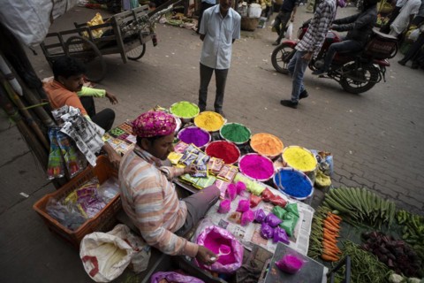 Vendor sells Holi celebration items in a street market, ahead of Holi festival on March 23, 2024 in