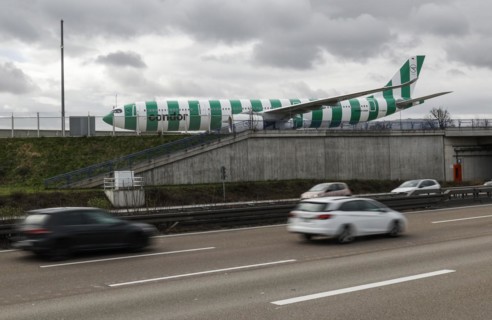An Airbus A330 Neo from Condor crosses a bridge next to the A3 motorway at Frankfurt Airport, 16.03