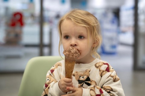 Interior shot, girl, 2-3 years, blonde, eating chocolate ice cream, ice cream, waffle, mouth