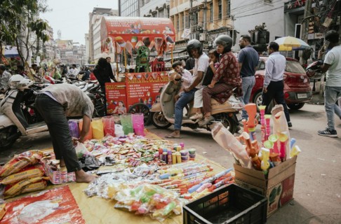Vendor sells Holi celebration items in a street market, ahead of Holi festival on March 23, 2024 in