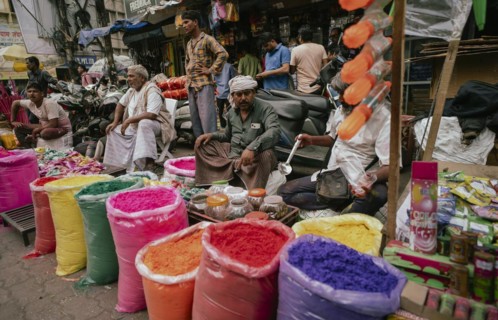 Vendor sells Holi celebration items in a street market, ahead of Holi festival on March 23, 2024 in