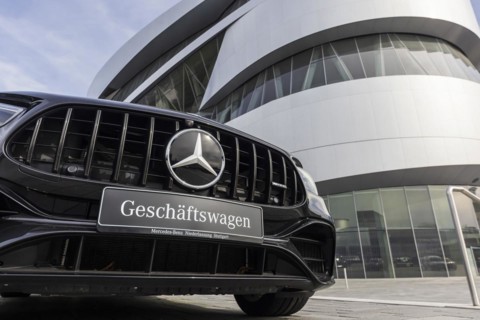 Mercedes company car, radiator grille and Mercedes star on a modern vehicle, in the background the