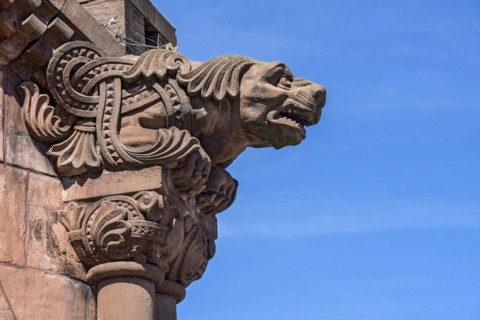 Gargoyle, demonic animal figure at the pavilion, historic Wilhelmine railway station, red