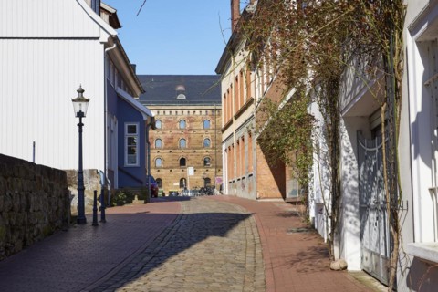 Alley Martinikirchhof with cobblestones and lantern in the city centre of Minden, Muehlenkreis