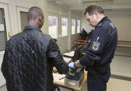Refugees are registered and recorded by the Federal Police in Rosenheim. A Federal Police officer