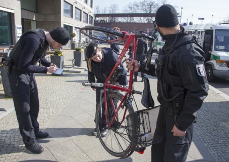 Berlin police officers check the chassis number of a bicycle during a traffic stop, 20/03/2015