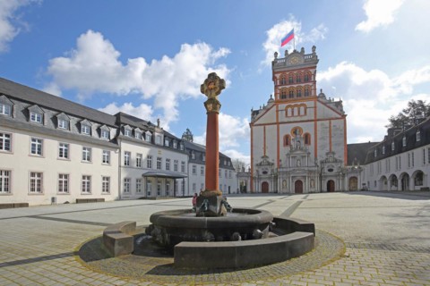 Forecourt with fountain, cross and column and Romanesque St Matthias Church, Benedictine Abbey,
