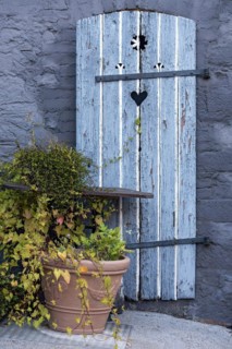 Old farmhouse, facade, decorated, flower pots, knotweed (Fallopia baldschuanica), weathered wooden