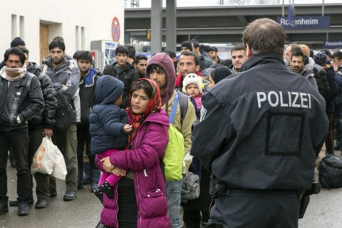 Refugees arriving at Rosenheim station, being taken to registration by federal police officers,