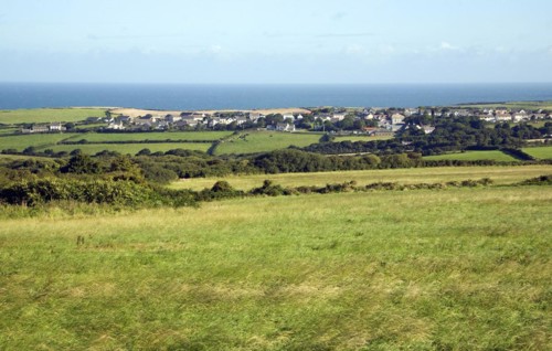 Linear coastal village of Trefin, viewed over fields, Pembrokeshire, Wales, United Kingdom, Europe