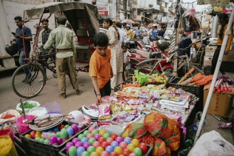 Vendor sells Holi celebration items in a street market, ahead of Holi festival on March 23, 2024 in