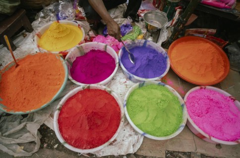 Vendor sells Holi celebration items in a street market, ahead of Holi festival on March 23, 2024 in