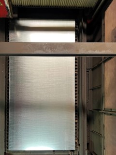 Top view of a table with a steel sheet being cut on a metal laser cutting machine
