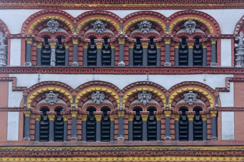 Detail with window, columns and grimaces from the tower of the Romanesque church of St Matthias,