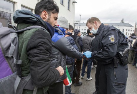 After arriving at Rosenheim station, refugees are given wristbands by federal police officers for