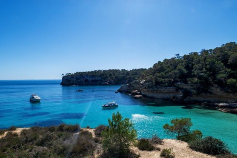 Private boats anchored in the bay in front of Playa El Mago, Cala de Portals Vells, Majorca,