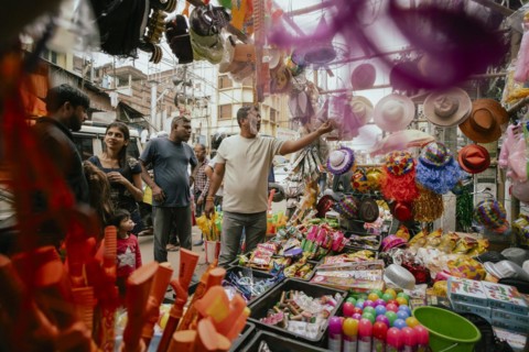 Vendor sells Holi celebration items in a street market, ahead of Holi festival on March 23, 2024 in