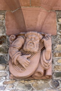 Console under bay window, ornamental console with relief in sandstone, musician with lute, old