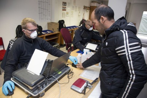 Refugees are registered and recorded by the Federal Police in Rosenheim. A Federal Police officer