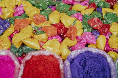 Vendor sells Holi celebration items in a street market, ahead of Holi festival on March 23, 2024 in