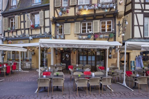 Catering establishments in historic half-timbered houses with watering cans decorating the facade