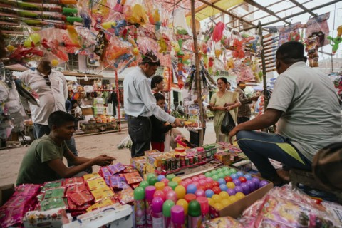 Vendor sells Holi celebration items in a street market, ahead of Holi festival on March 23, 2024 in