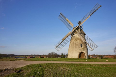 Windmill Auf der Hoechte under a cloudless blue sky is part of the Westphalian Mill Road in Hille,