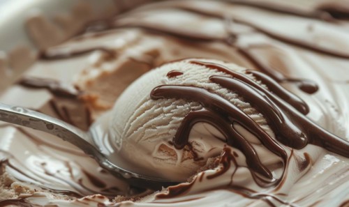 Ice cream scoop with chocolate syrup swirls closeup view AI generated