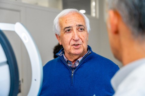 Satisfied senior man talking to an ophthalmologist in the clinic after receive an innovative