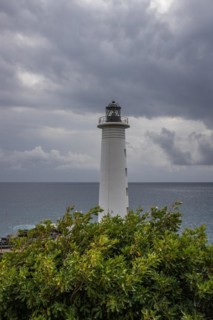 Le Phare du Vieux-Fort, white lighthouse on a cliff. Dramatic clouds with a view of the sea. Pure