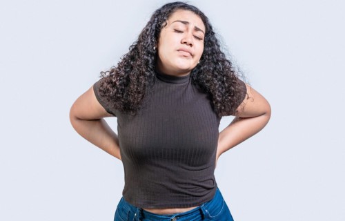 Girl with spine problems isolated. Woman with back pain on isolated background. lumbar problems
