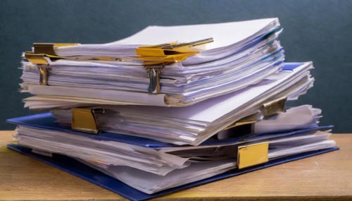 High stacks of files with clips and labels, symbol for office work and organisation, symbol for