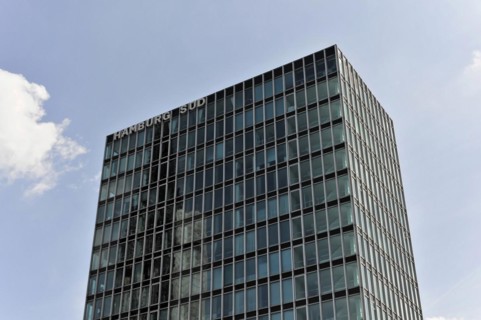 Hamburg Sued Reederei, A modern high-rise building with a reflective glass facade rises into the