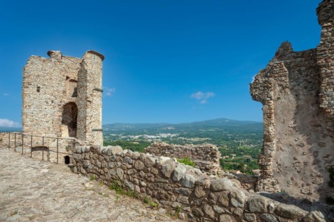 Ruins of Grimaud Castle with a view of the village of Grimaud, in the background the hills of the