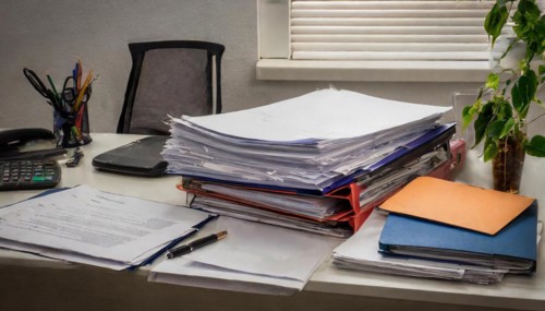 A messy desk with high piles of paper and office supplies, symbolism bureaucracy, AI generated, AI