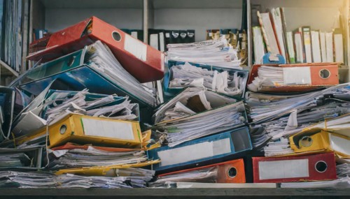 A jumble of overfilled folders and loosely stacked papers, symbol bureaucracy, AI generated, AI