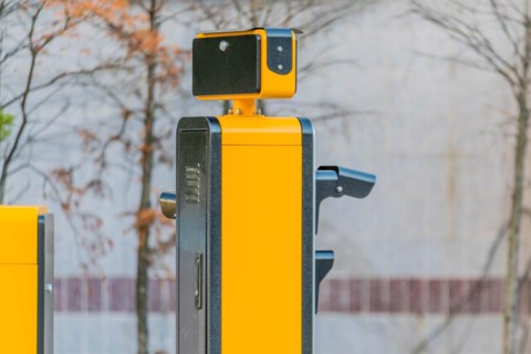 Side view of device to read license plates and calculate charges as cars enter and exit parking