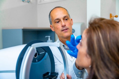 Ophthalmologist checking the eye of a woman during treatment for glaucoma using innovative laser